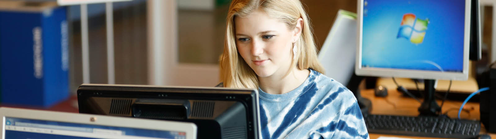 Summer at FLCC. A student using a laptop to access online course information.