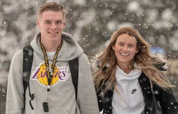 FLCC student outside main building. Snow covered tree in background