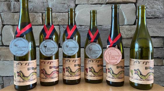 The 2022 Origin vintage displayed with four silver and one bronze medals from the New York Wine Classic.